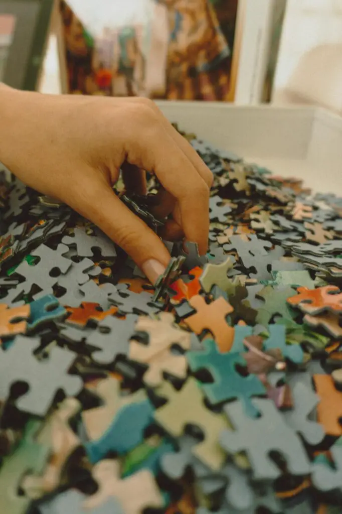 A person is putting pieces of a puzzle together